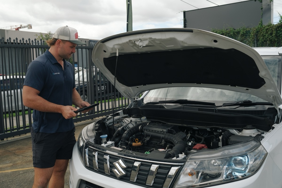 Nathan, your Fast RWC inspector, checking a car's engine bay with the inspection tablet